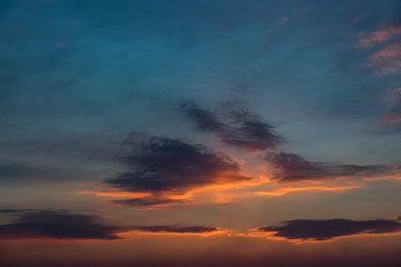 Obraz premium Dramatic sunset sky with orange colored clouds.