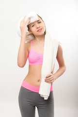 Young athletic girl finished training, holding a bath towel