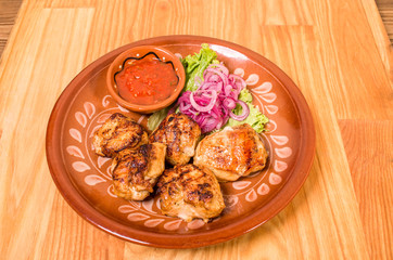 Grilled chicken thighs with garnish.