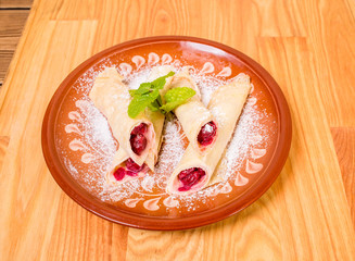 Traditional pancakes with cherry.