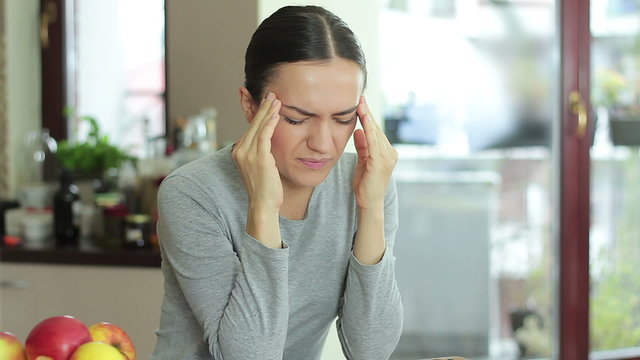 Young woman suffering from headache migraine pain
