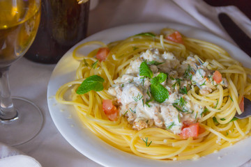 Cheese pasta with chicken and mushrooms and the wine in the glass