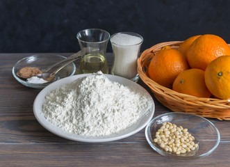 Baking cookies with mandarins in the kitchen - dough recipe ingredients (flour,butter,nuts,sugar)