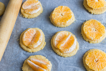 Freshly prepared dough Tangerine cookie with a rolling pin
