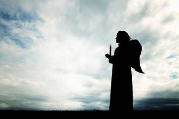 Angel silhouette at sunset