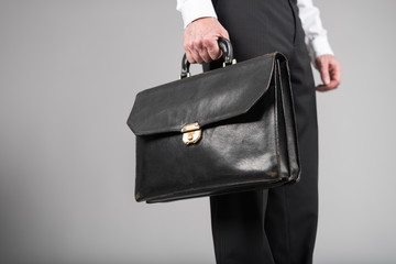 Businessman standing and holding a briefcase