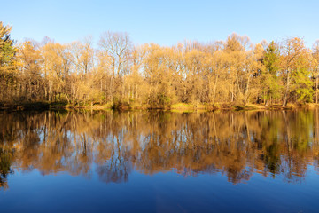 Fototapeta na wymiar autumn landscape with symmetrical reflection