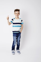 Young boy with thumbs up, studio