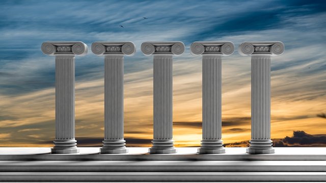 Five ancient pillars with sunset sky background.