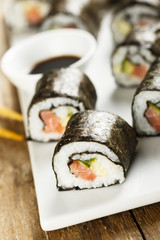 Fish and vegetable sushi on white plate