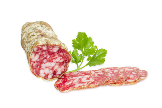 Salami and sprig of parsley on a light background