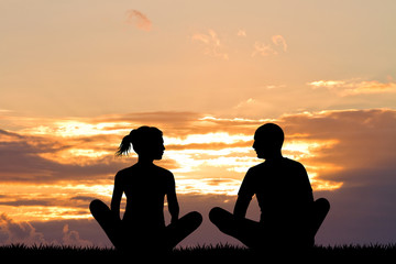 yoga couple silhouette at sunset