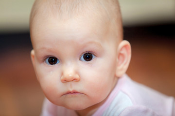 Close-up of a small child who cries but does not scream. A tear rolling down his cheek. Blurred background. Photo girl.