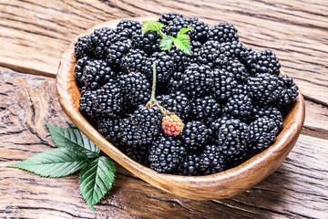 Blackberries in the wooden bowl.