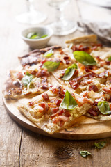 Flammkuchen pie with bacon and onion