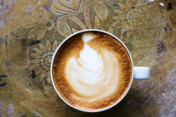 Vintage image of Top view of cappuccino coffee , in white cup.
