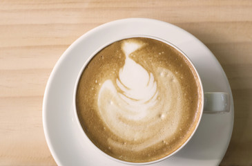 Vintage image of Top view of cappuccino coffee , in white cup.