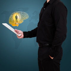 Businessman show brain with Light Bulb in palm.