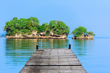 wooden bridge juts out into  of the sea