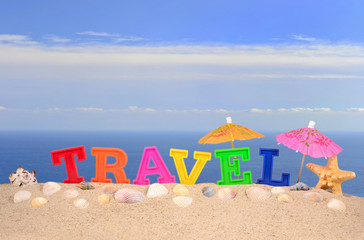 Travel letters on a beach sand