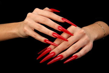 Pretty woman hand with perfect painted nails isolated on black background