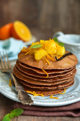 Chocolate pancakes with oranges.