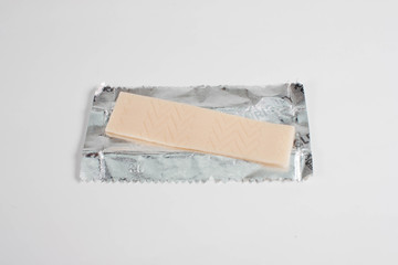 chewing gum is on the white background with paper. 