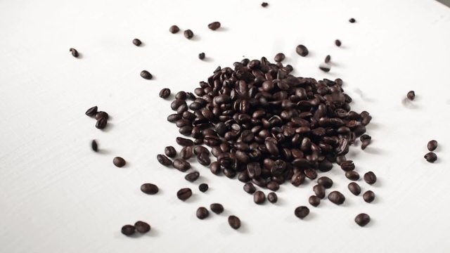 Coffee beans are strewed on the table