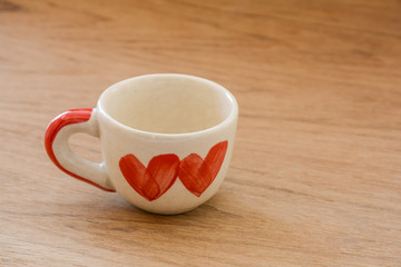 Close up of cup of love with wooden table