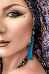 Half face portrait beautiful woman, arabic makeup, colorful turban