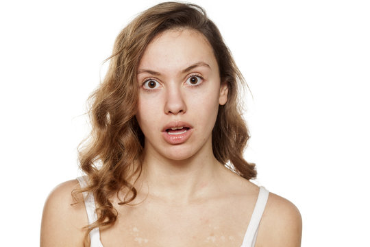 unpleasantly surprised young woman without make-up