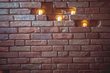 candles in brick wall