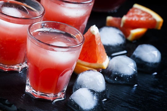 Cool Juice From Blood Orange With Ice Cubes On A Dark Background