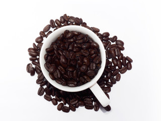 Close-Up Of Roasted Coffee Beans In Cup On White Background
