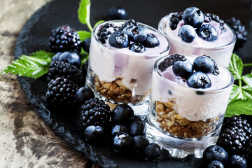 Dessert of oatmeal, yogurt, blackberries and blueberries in glas