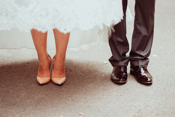 feet of bride and groom standing in the room