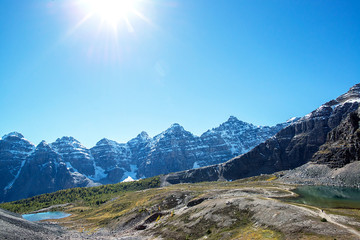 hiker on a small trail in the Valley of the Ten Peaks in the national park of banff in the rocky mountains of alberta canada