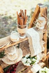 Fototapeta na wymiar rustic wedding decoration with cinnamon and flowers