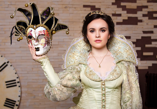 Girl with venetian mask in hand
