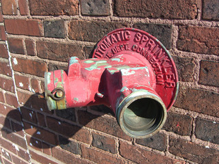 Hose connection for fire department on brick wall