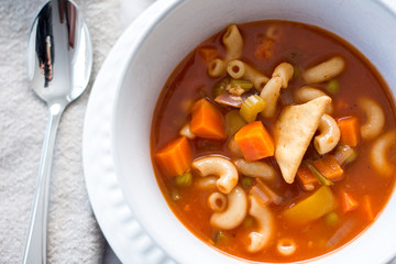 vegetable and pasta soup on a white background