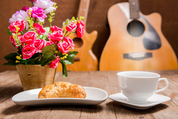 hot coffee and croissant on wooden