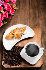 hot coffee and croissant on wooden