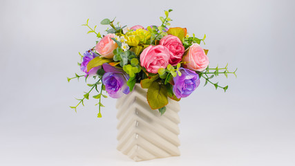 plastic colorful flower in vase on white background