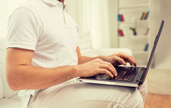 close up of man working with laptop at home