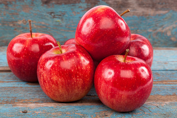 Fresh red apples on wooden boards.