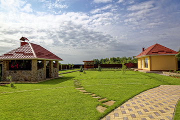 Green lawn and buildings in the backyard