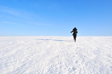Fototapeta na wymiar girl running through a snowy field