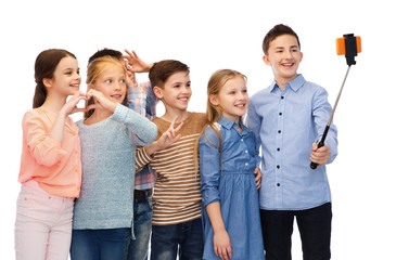 happy children with smartphone and selfie stick