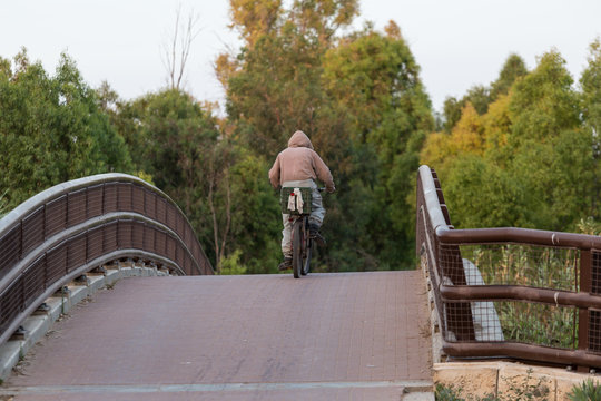 man rides a bicycle bridge
